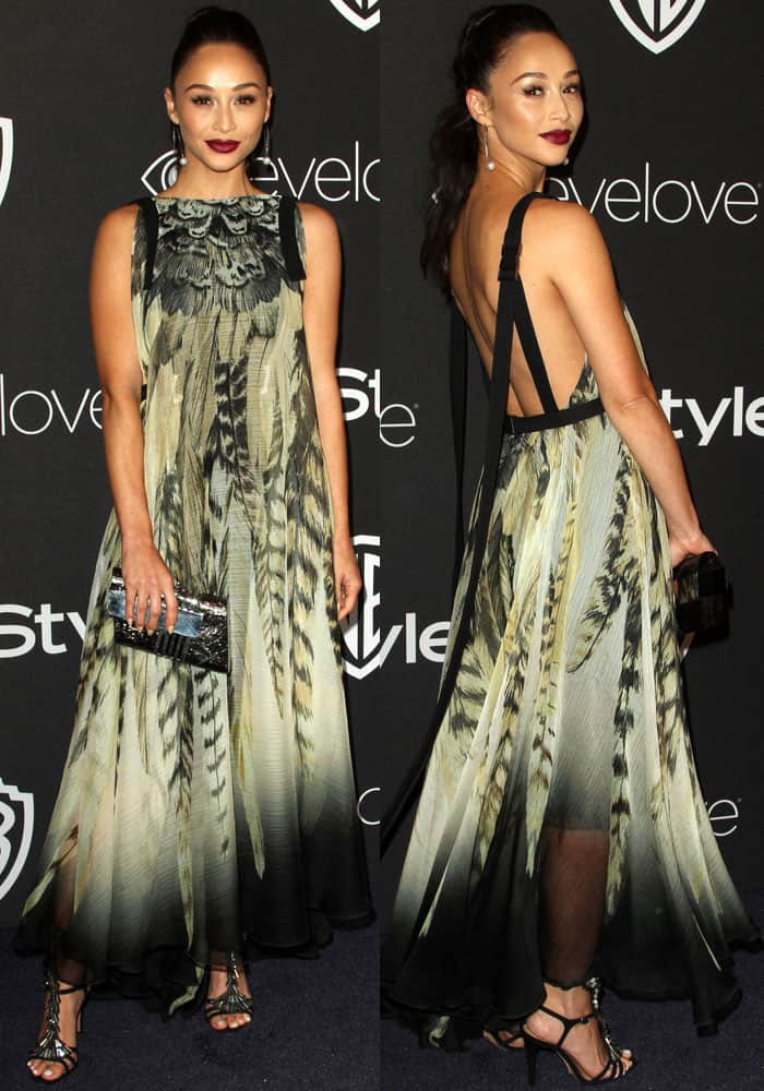 Cara Santana dazzles in a feather-print Tadashi Shoji dress with a backless design, paired elegantly with Schutz sandals and an Emm Kuo clutch