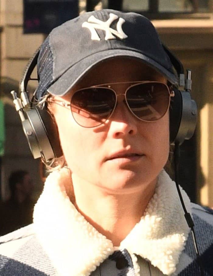 Diane Kruger keeps it casual in New York City with a Yankees baseball cap, aviator sunglasses, and headphones