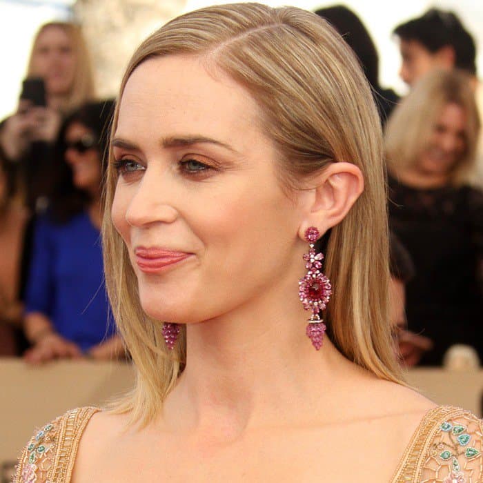 Emily Blunt completed her SAG Awards look with sleek blonde locks, subtle makeup, and eye-catching purple-hued chandelier earrings that added a pop of color