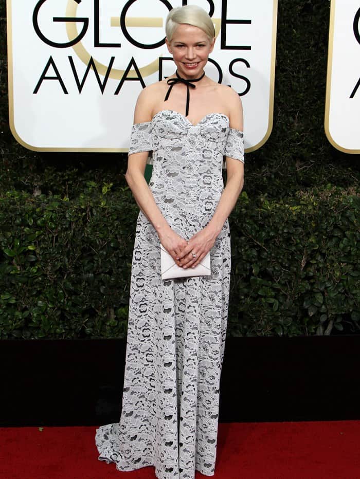 Michelle Williams brings vintage charm to the Golden Globes in an off-the-shoulder lace Louis Vuitton gown, finished with an unconventional black ribbon choker