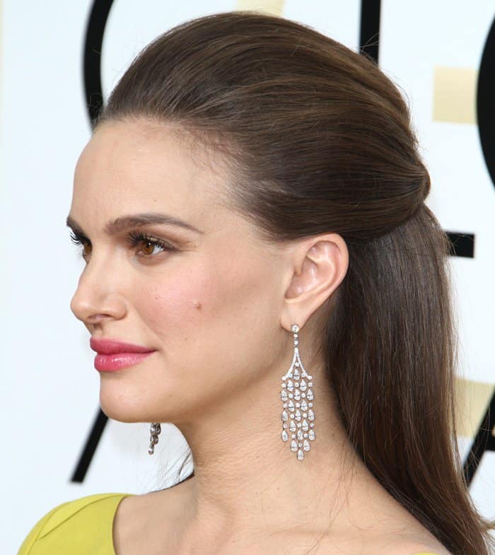 Natalie Portman completes her elegant Golden Globes look with vintage Tiffany Co. fringe earrings and a softly voluminous half-up hairstyle