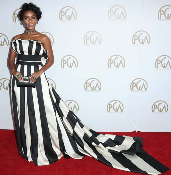 Make a bold statement like Janelle Monáe by pairing a black-and-white striped ball gown with emerald jewelry and a sleek updo for a modern, red-carpet-inspired look
