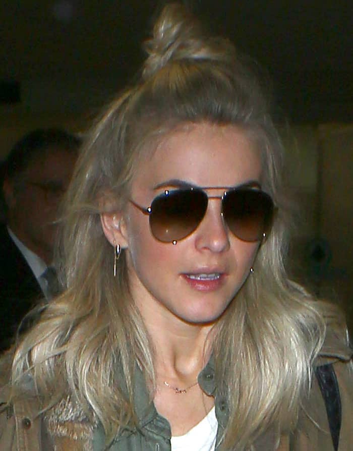 Julianne Hough completes her laid-back airport look with oversized aviator sunglasses and a trendy half-up bun hairstyle