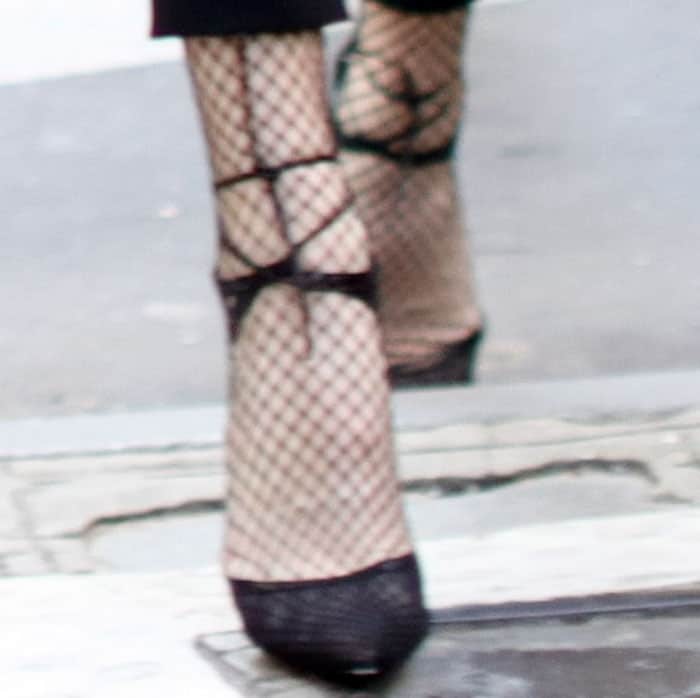 A close-up captures the delicate mesh and crisscross straps of her heels, highlighting how texture and transparency elevate the pointed-toe silhouette