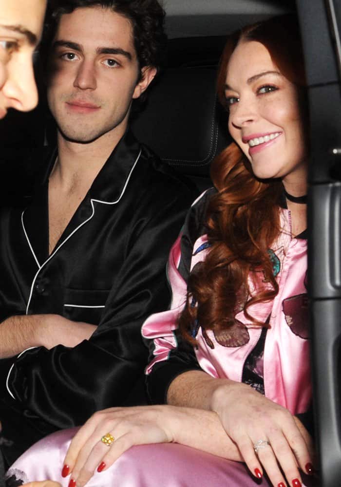 Lindsay Lohan and her new friend Tommaso Zorzi embrace the sleepwear-inspired trend while partying in Milan, showcasing chic and relaxed fashion choices