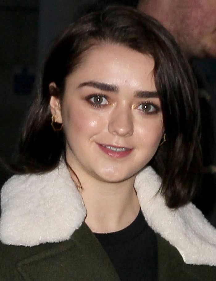 Maisie Williams showcases her effortless beauty with natural makeup, glowing skin, and sleek shoulder-length hair styled in a classic side part