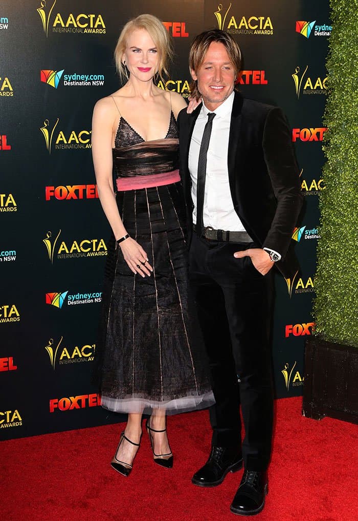 Nicole Kidman, towering in her Salvatore Ferragamo pumps and gothic-inspired Rochas dress, playfully highlights the height difference with her husband Keith Urban