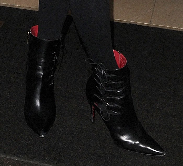 Paris Hilton steps out in sleek Cesare Paciotti leather booties featuring pointed toes, lace-up detailing, and bold red accents, perfectly complementing her polished look