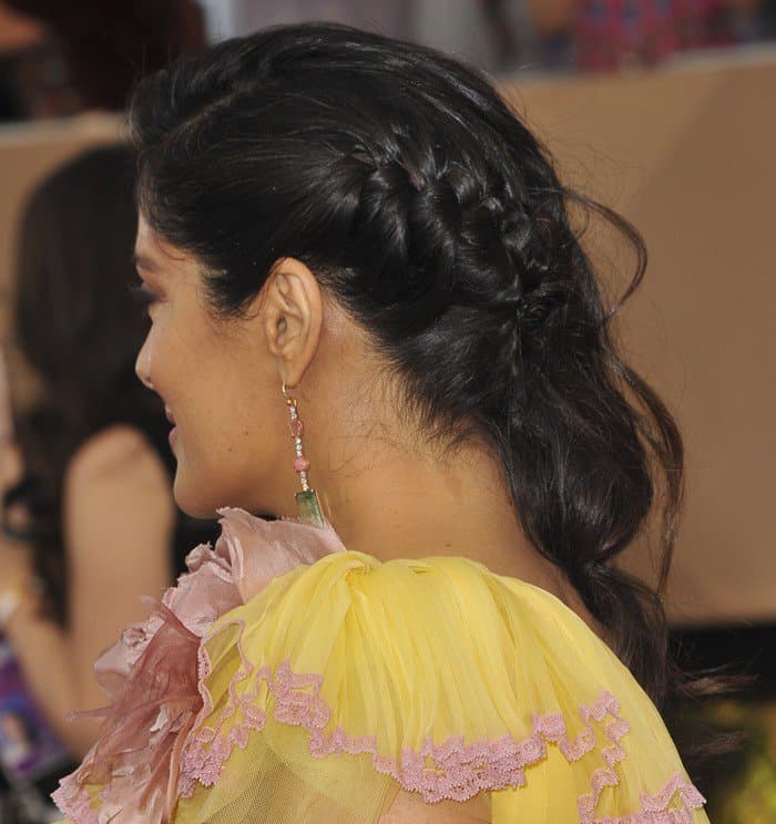 Salma Hayek showcased a chic braided updo, accentuating the floral details of her canary yellow Gucci gown at the 2017 SAG Awards