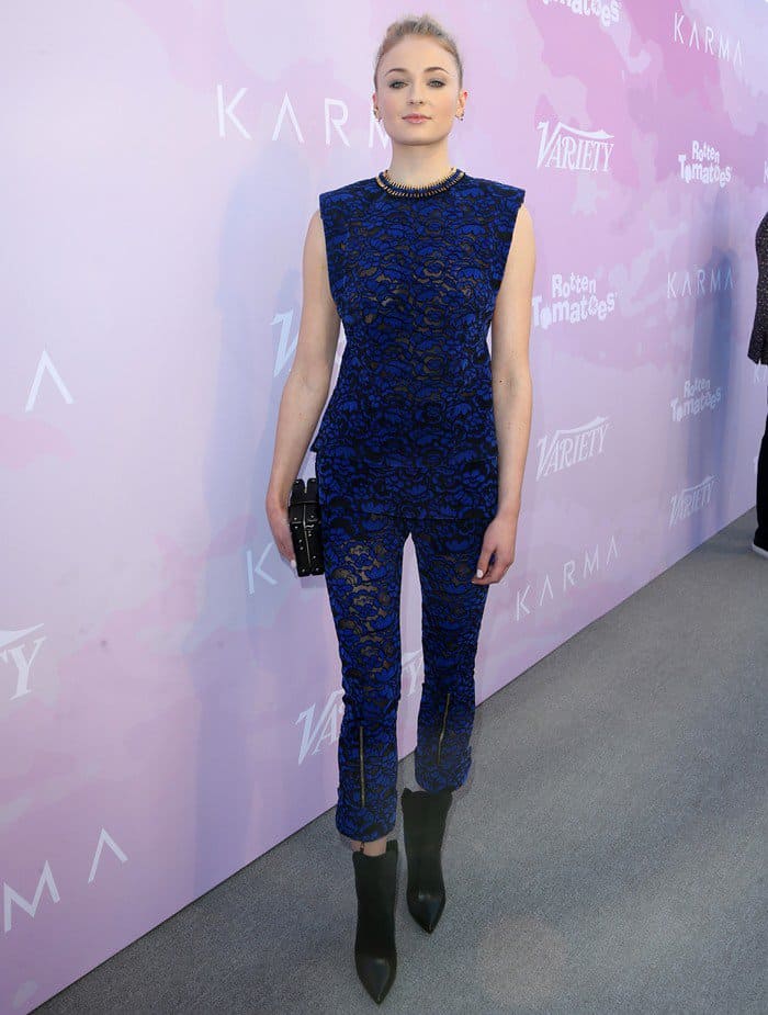 Sophie Turner gives the illusion of a lace jumpsuit in a sheer Louis Vuitton tunic and matching cropped trousers, styled with a minimalist clutch and sleek color-block booties at Variety’s Celebratory Brunch at Cecconi’s in West Hollywood on January 28, 2017