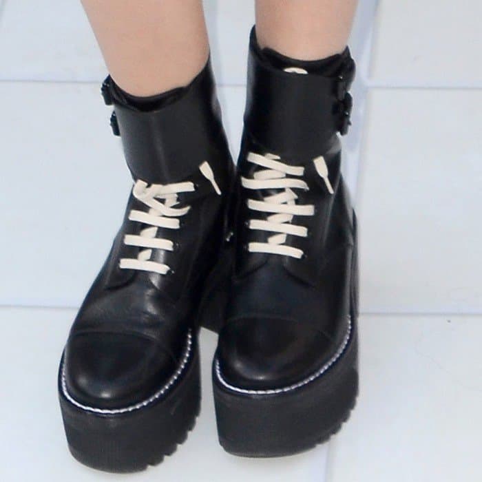 Ashley Tisdale's Louis Vuitton “Fighter” platform half boots feature chunky lug soles, contrasting white laces, and oversized proportions that add a rebellious edge to an otherwise polished outfit