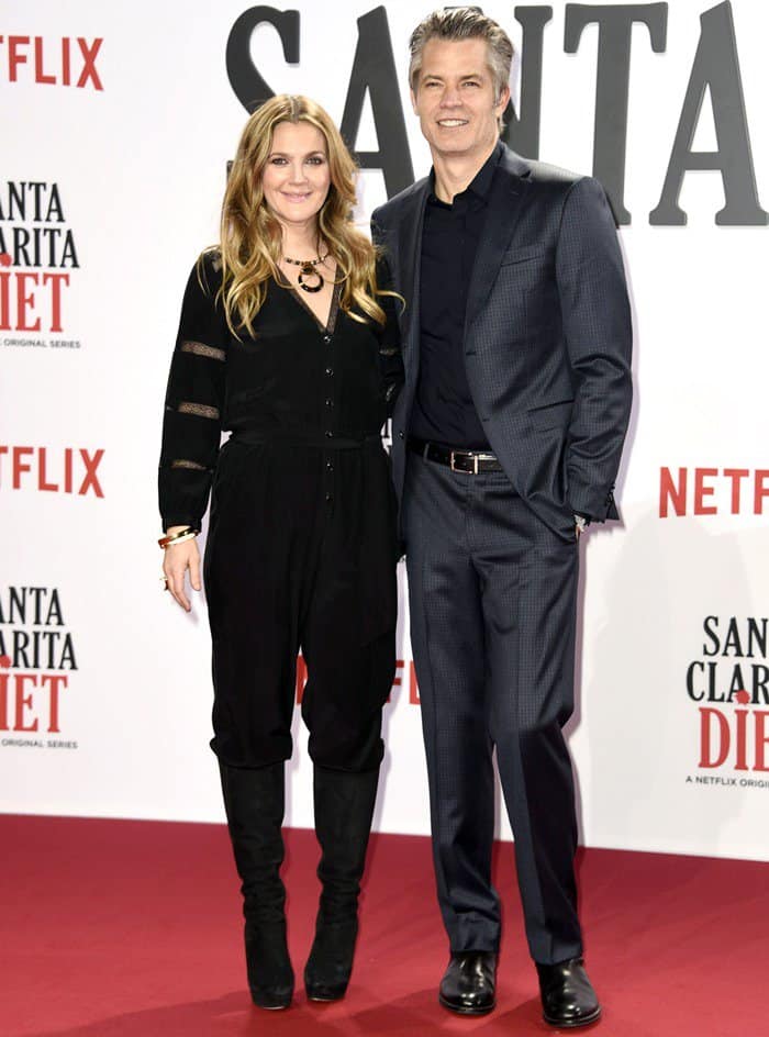 Drew Barrymore, posing with her co-star Timothy Olyphant, wore black suede boots at the premiere of their new Netflix series 'Santa Clarita Diet' at CineStar in Berlin