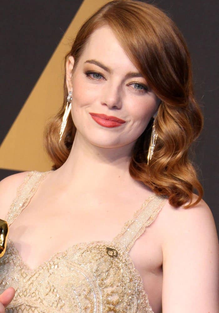 Emma Stone radiates elegance with her vintage waves and dazzling drop earrings