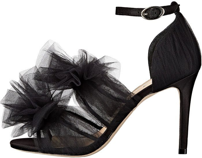 Isa Tapia’s black “Gigi” tulle sandal features soft layered tulle ruffles, a slim ankle strap, and a sculptural, romantic silhouette that defines the designer’s signature feminine aesthetic