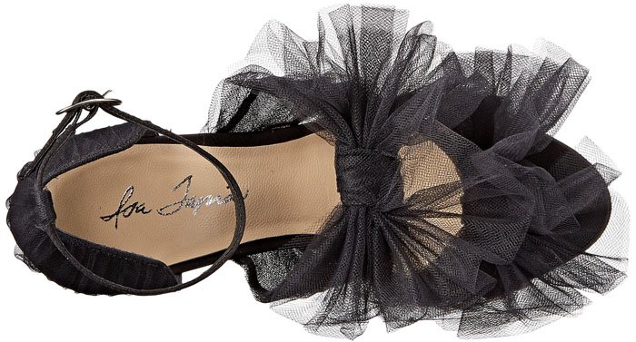 Isa Tapia’s black “Gigi” tulle sandal features soft layered tulle ruffles, a slim ankle strap, and a sculptural, romantic silhouette that defines the designer’s signature feminine aesthetic