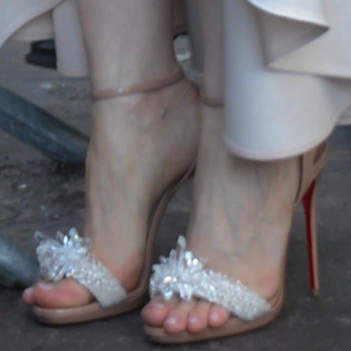 Jessica Chastain shows off a soft pink pedicure in Christian Louboutin’s 'Crystal Queen' embellished sandals, featuring sparkling crystal shards and a sleek nude patent base