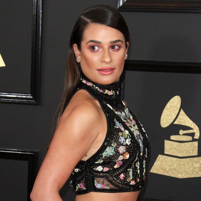 Lea Michele stuns in a high-neck floral-embroidered crop top featuring intricate beading and sheer paneling