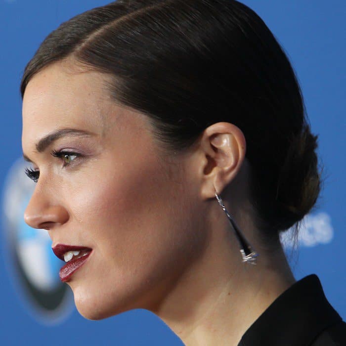 A closer look at Mandy Moore's refined elegance, featuring eye-catching statement earrings that perfectly frame her face and complete her red carpet aesthetic