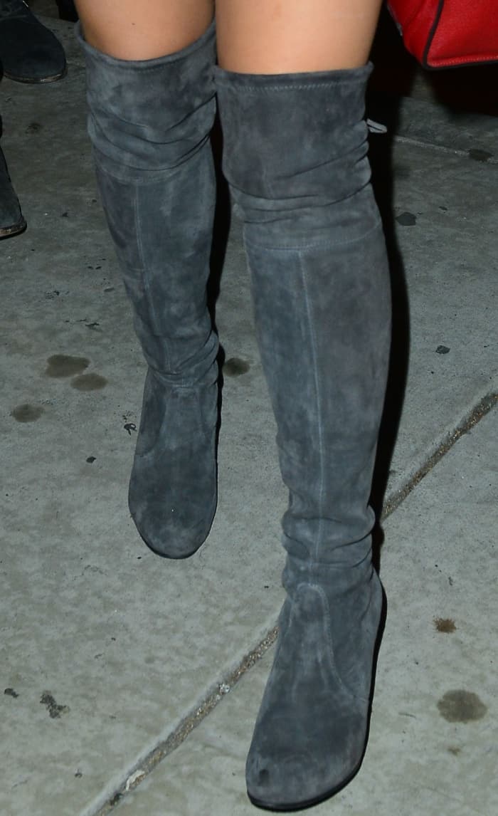 Ariel Winter steps out in chic gray suede over-the-knee boots featuring a sleek, slouchy design and chunky heels, perfect for elevating any night-out look