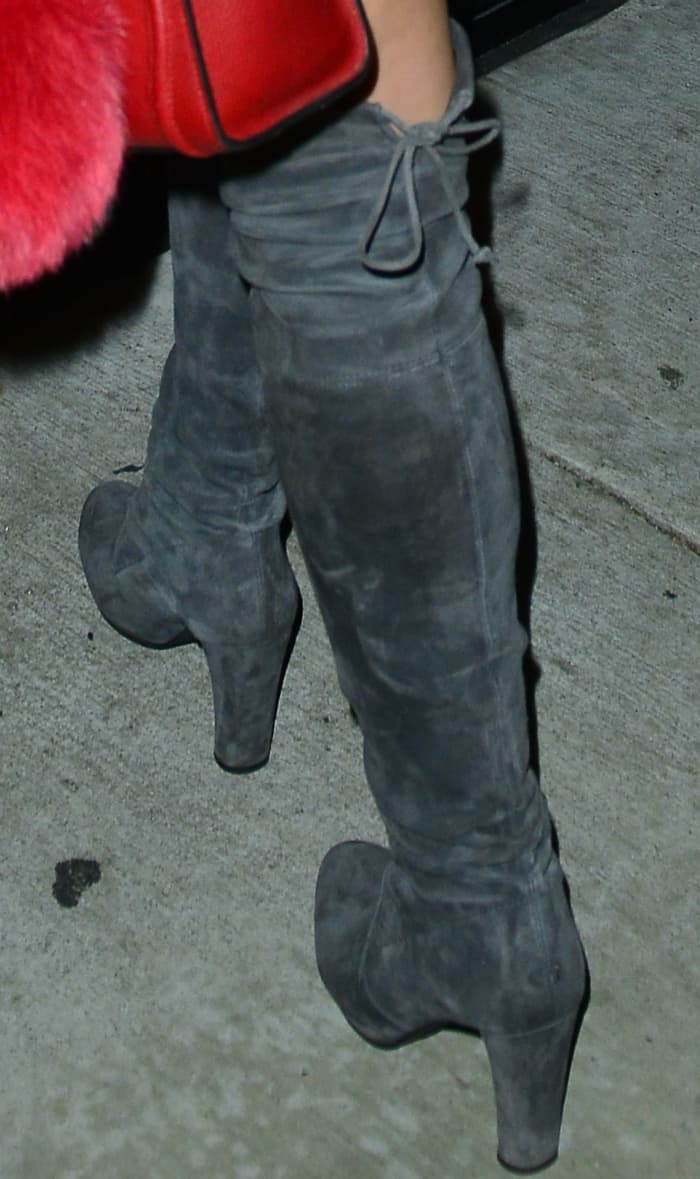Ariel Winter steps out in chic gray suede over-the-knee boots featuring a sleek, slouchy design and chunky heels, perfect for elevating any night-out look