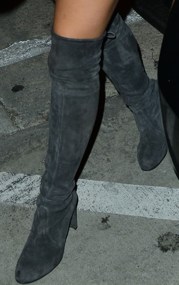Ariel Winter steps out in chic gray suede over-the-knee boots featuring a sleek, slouchy design and chunky heels, perfect for elevating any night-out look