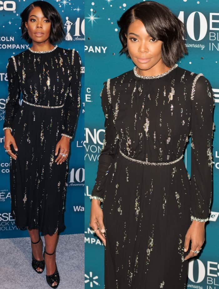 Gabrielle Union dazzles in a black Prada dress adorned with jeweled embellishments and paired with chic ankle-strap heels