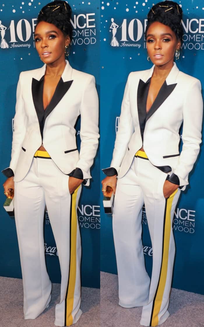 Janelle Monáe stunned in a tailored white Barbara Bui suit with contrasting black lapels and bold yellow side stripes, completing the sleek look with a structured clutch and gold statement jewelry for a modern and polished appearance