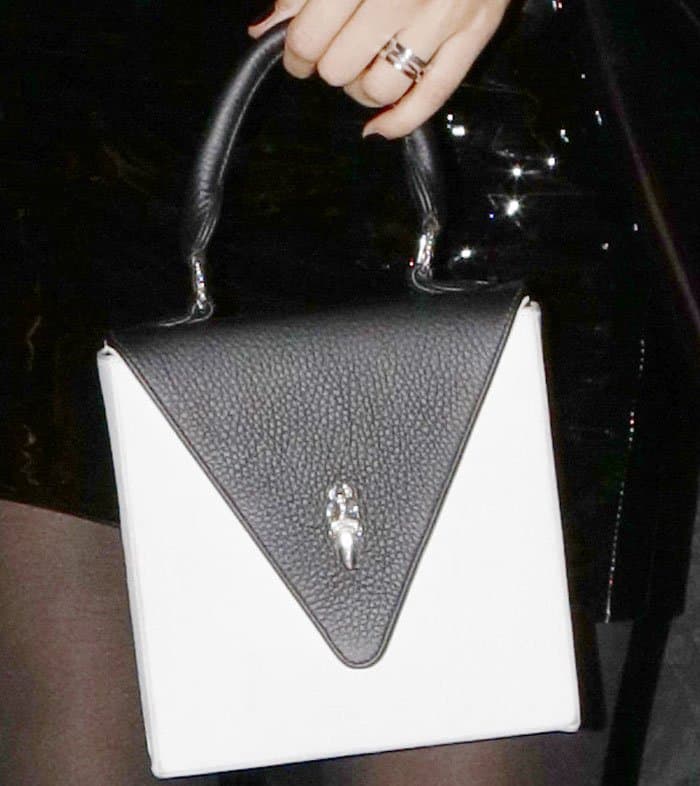 Bella shows off a square bag from her Chrome Hearts x Bella Hadid line