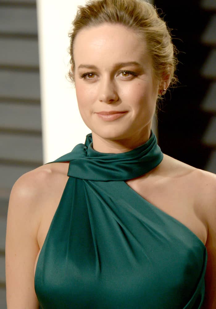 Brie Larson radiates elegance in an emerald green Ralph Russo gown, showcasing a sleek updo and natural makeup