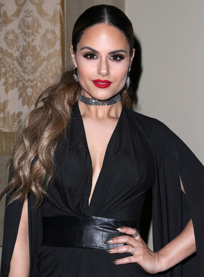 Pia Toscano exudes Hollywood glamour with a bold red lip and an elegant black ensemble, complete with a chic choker and sleek hairstyle