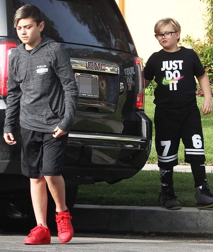 Kingston and Zuma trail their mother in sporty-casual outfits, offering a glimpse of a relaxed family outing in Los Angeles