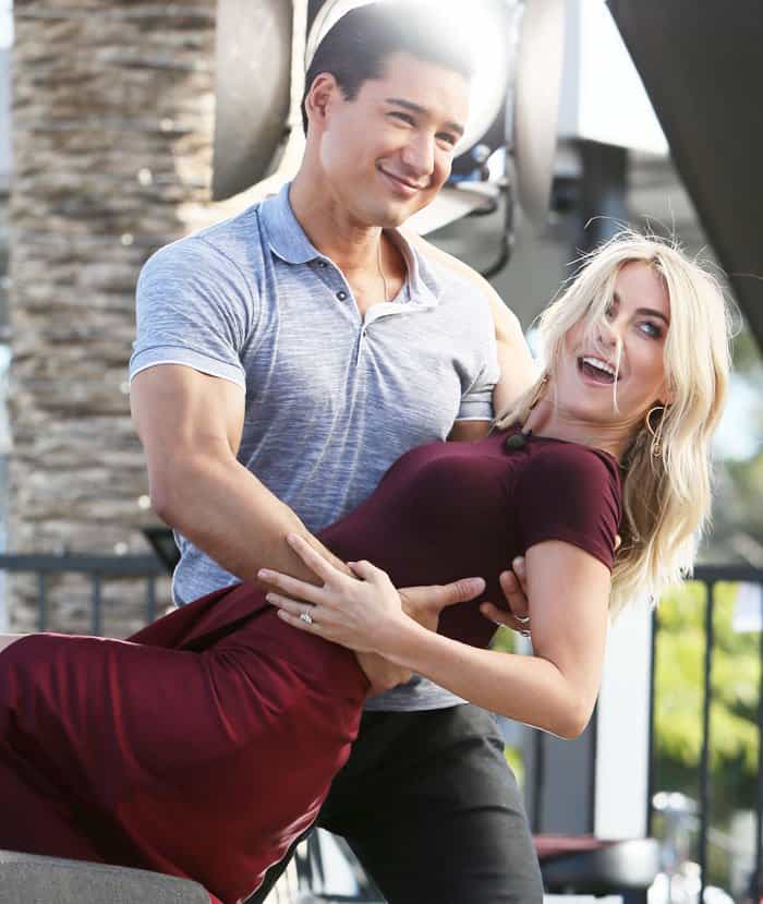 Extra host Mario Lopez shares a playful dance moment with Julianne Hough, showcasing their effortless chemistry and infectious energy on set