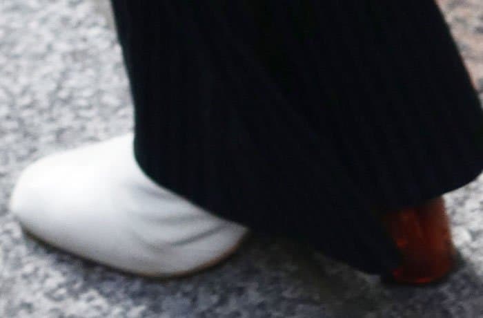 A closer look at Kendall’s Kurt Geiger “Strut” boots reveals their crisp white leather and chunky lucite heel