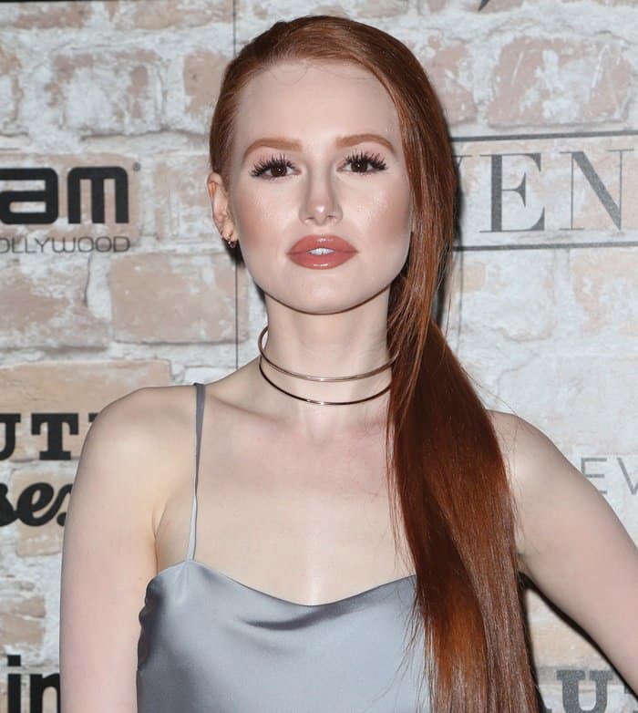 Madelaine Petsch completed the look with glossy waves, soft neutral makeup, and layered rose-gold chokers that complemented her copper-red hair