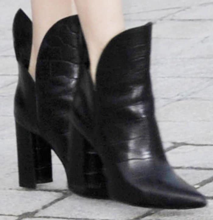 Michelle Williams steps out in Louis Vuitton's bold "Pokerface" boots, featuring a sculptural silhouette, pointed toe, and statement curved leather panels