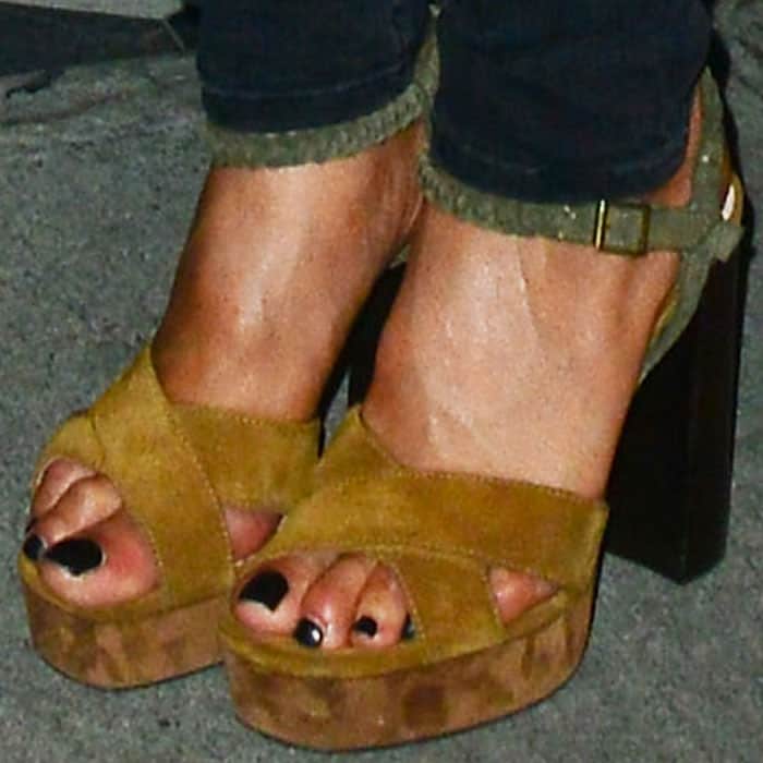 Nicole showed off a glossy black pedicure in her mustard yellow Lanvin suede platform sandals with chunky block heels and crisscross straps