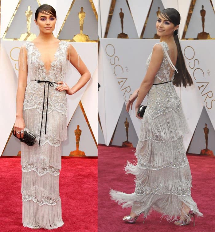 Olivia Culpo stuns in a custom Marchesa gown featuring intricate beadwork, layered fringe, and a delicate bow belt, perfectly blending vintage charm with modern elegance
