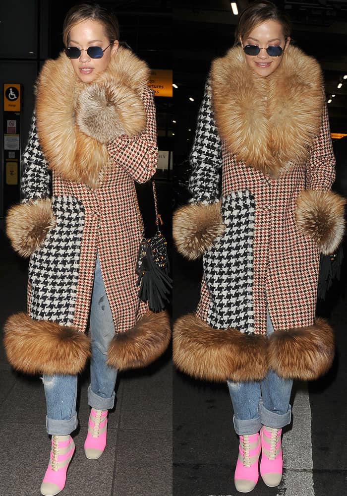 Rita Ora boldly showcases her Fendi sock boots, pairing them with an oversized Ellery tweed fur coat and distressed denim for a statement airport look upon her arrival from Milan
