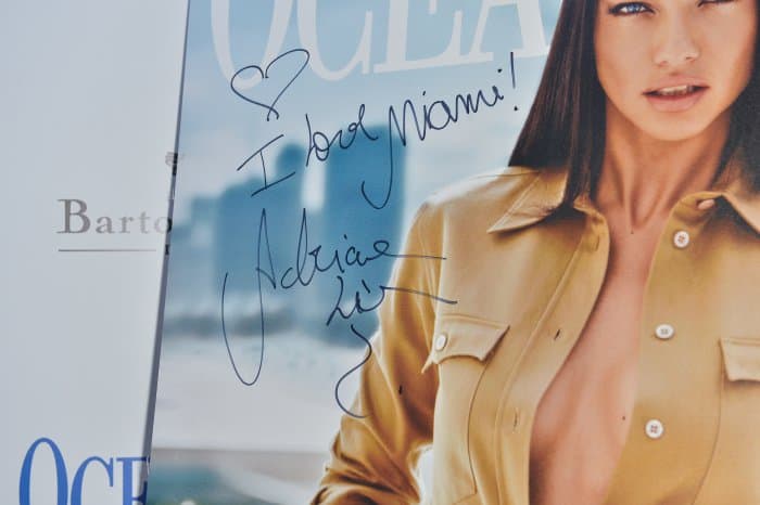 A signed message from Adriana Lima reading “I love Miami!” adorns her Ocean Drive magazine cover photo