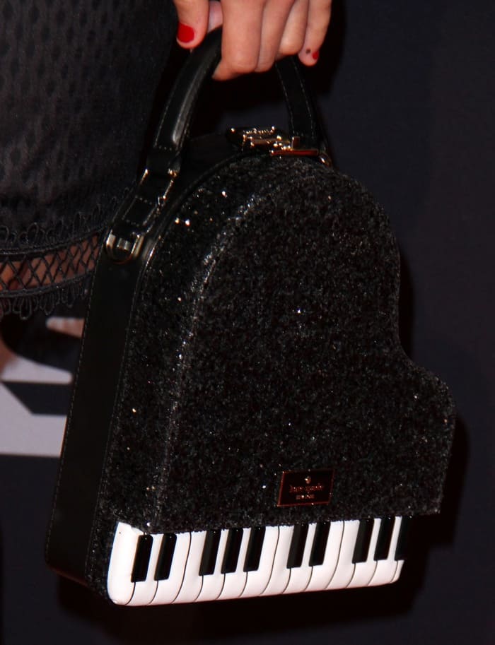 A glittering Kate Spade piano-shaped bag adds playful contrast, complementing the understated elegance of her footwear
