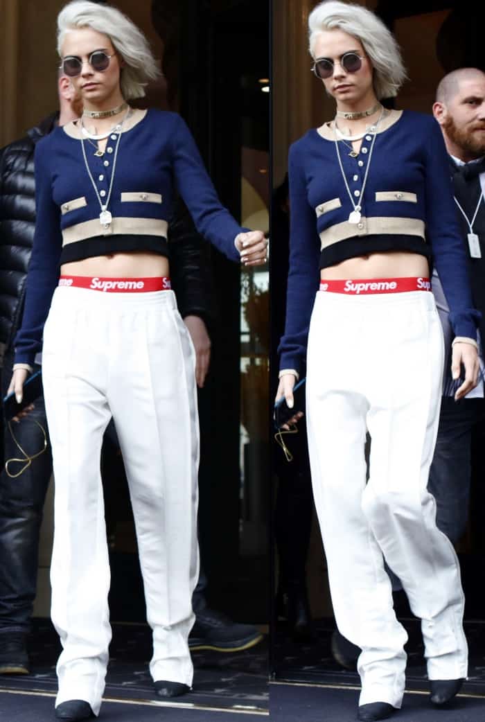 Effortlessly edgy, Cara Delevingne rocks a cropped Chanel cardigan, Supreme-branded joggers, and pointed-toe boots for a bold street-style statement in Paris