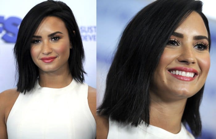 Demi Lovato keeps the focus on soft glamour with a sleek side-parted bob, fluttery lashes, and glossy pink lips