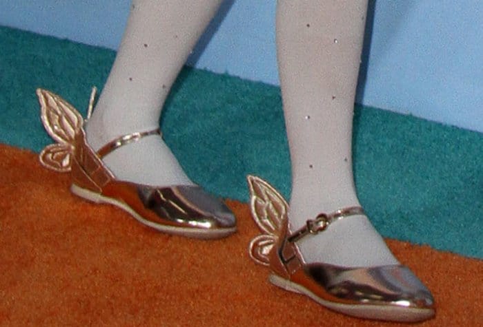 Monroe Cannon Carey wears white stockings with flat Sophia Webster shoes featuring butterfly wings