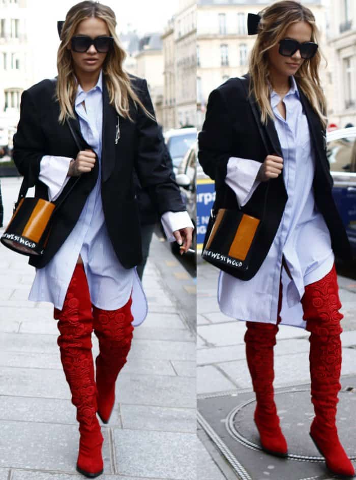 Rita Ora turns heads in an oversized blazer, striped shirtdress, and bold red embroidered thigh-high boots, effortlessly blending power dressing with street-style flair