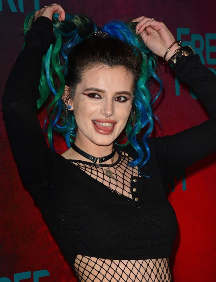 Bella Thorne's hair, styled in a ponytail, features a hint of her signature turquoise color at the ends
