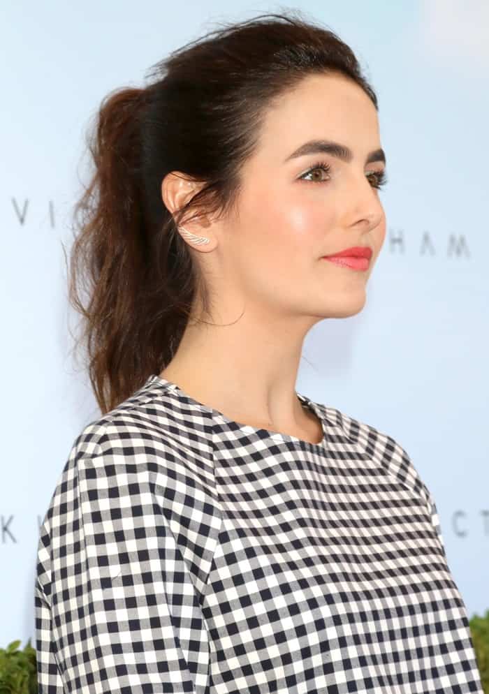 Camilla Belle showcases a chic high ponytail and sleek makeup look at the Victoria Beckham for Target launch in NYC