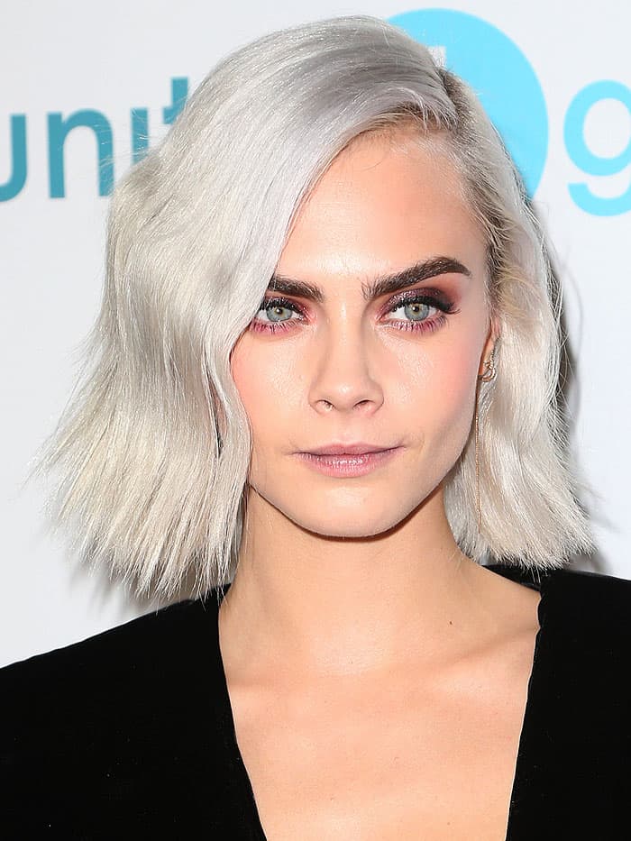 Cara Delevingne debuts a bold beauty statement with winged berry-toned lipstick and a striking platinum bob at the unite4:humanity gala