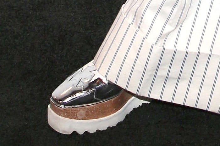 Charli XCX's Stella McCartney "Elyse" star-cutout platform oxford creepers peeking out from the cuffed hem of her pinstriped wide-leg pants