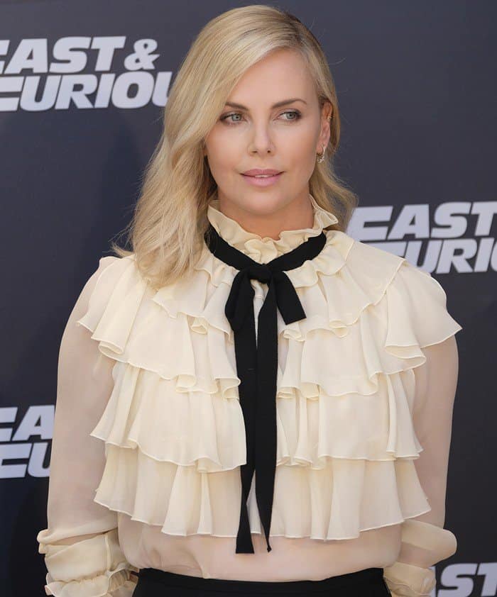 Charlize Theron wearing a Gucci flounce long sleeve shirt