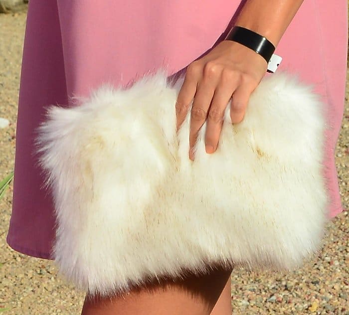 Lucy Mecklenburgh added a playful touch to her pink ensemble with a fluffy white faux fur clutch